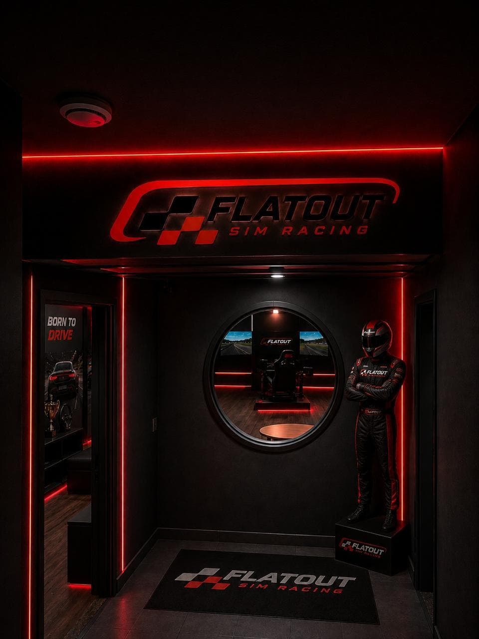 Race suit on display at the entrance, rig visible through the porthole mirror